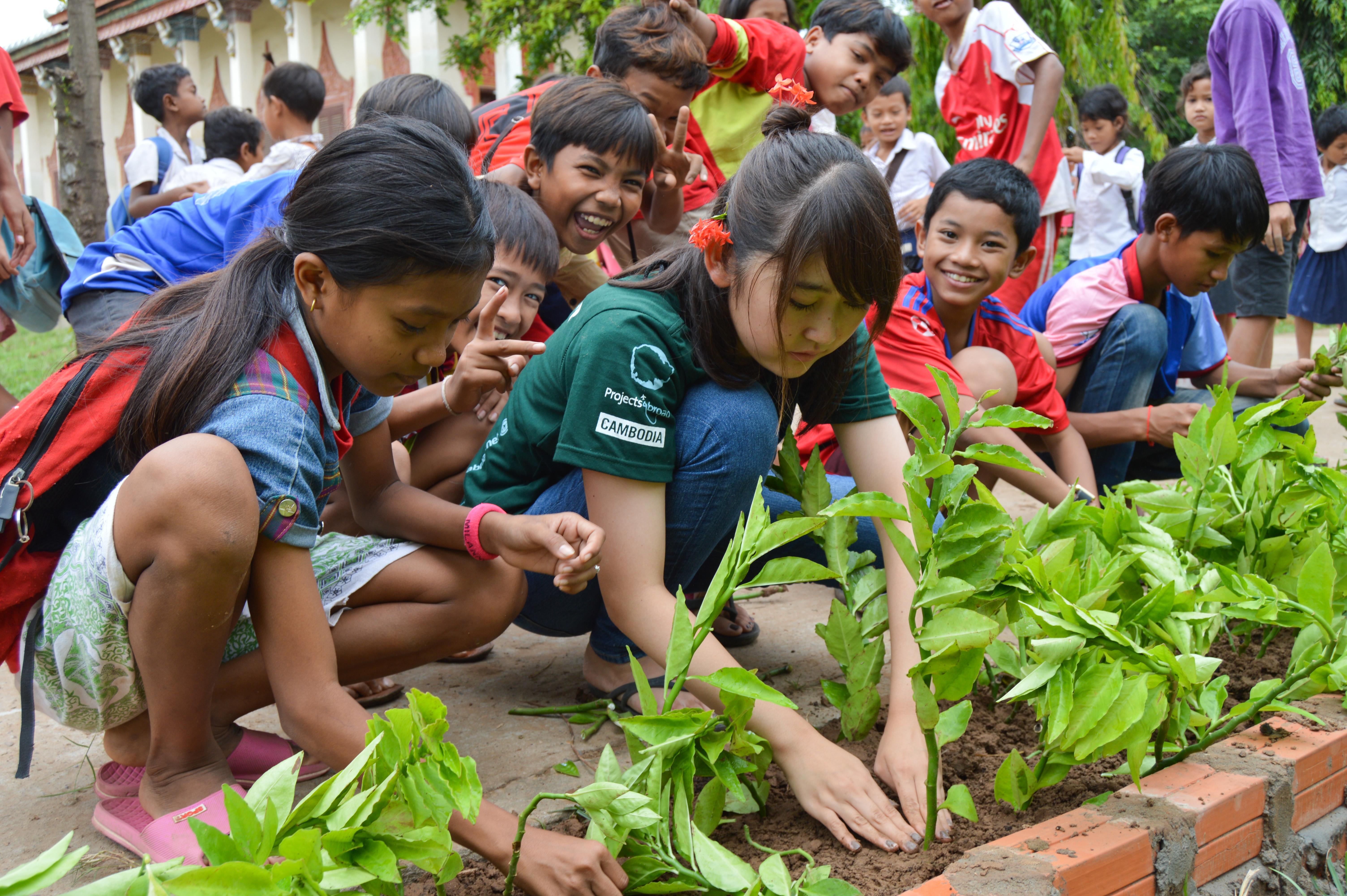 A short term volunteer planting flowers