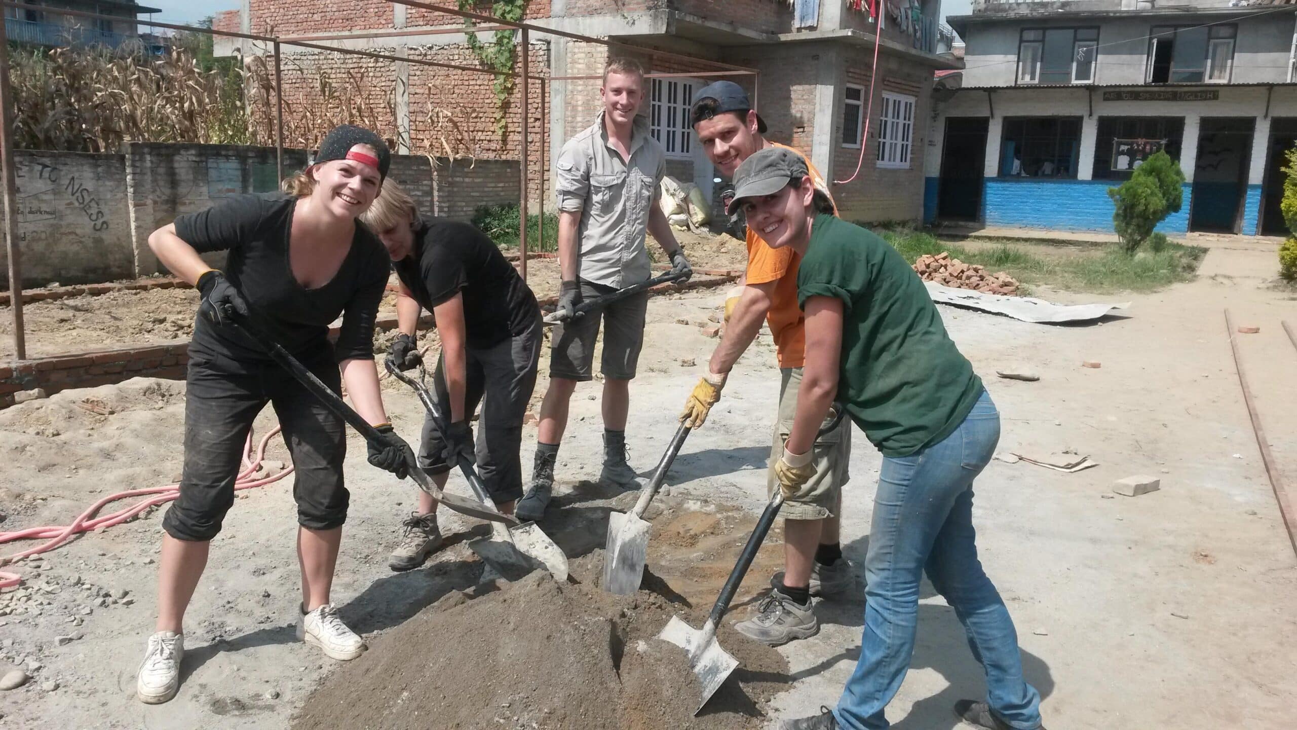 A group of volunteers dig foundations for a school at the 2015 Disaster Relief placement in Nepal
