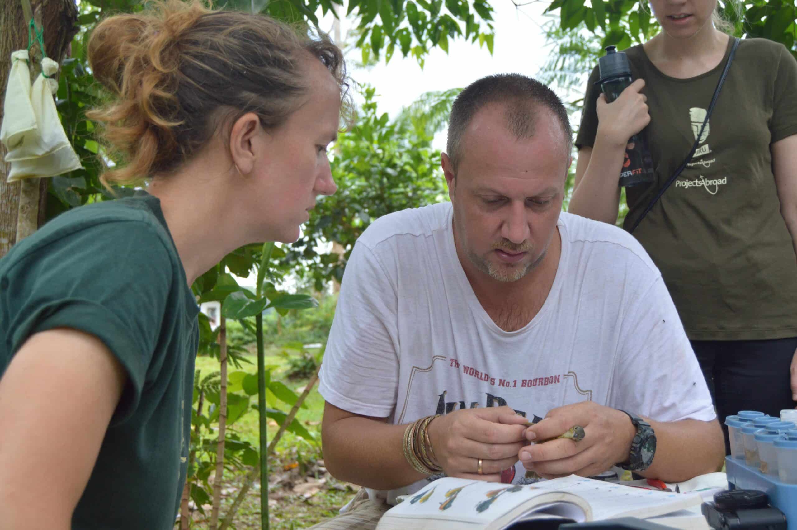 Stuart Timson helping a Conservation volunteer with one of her daily tasks
