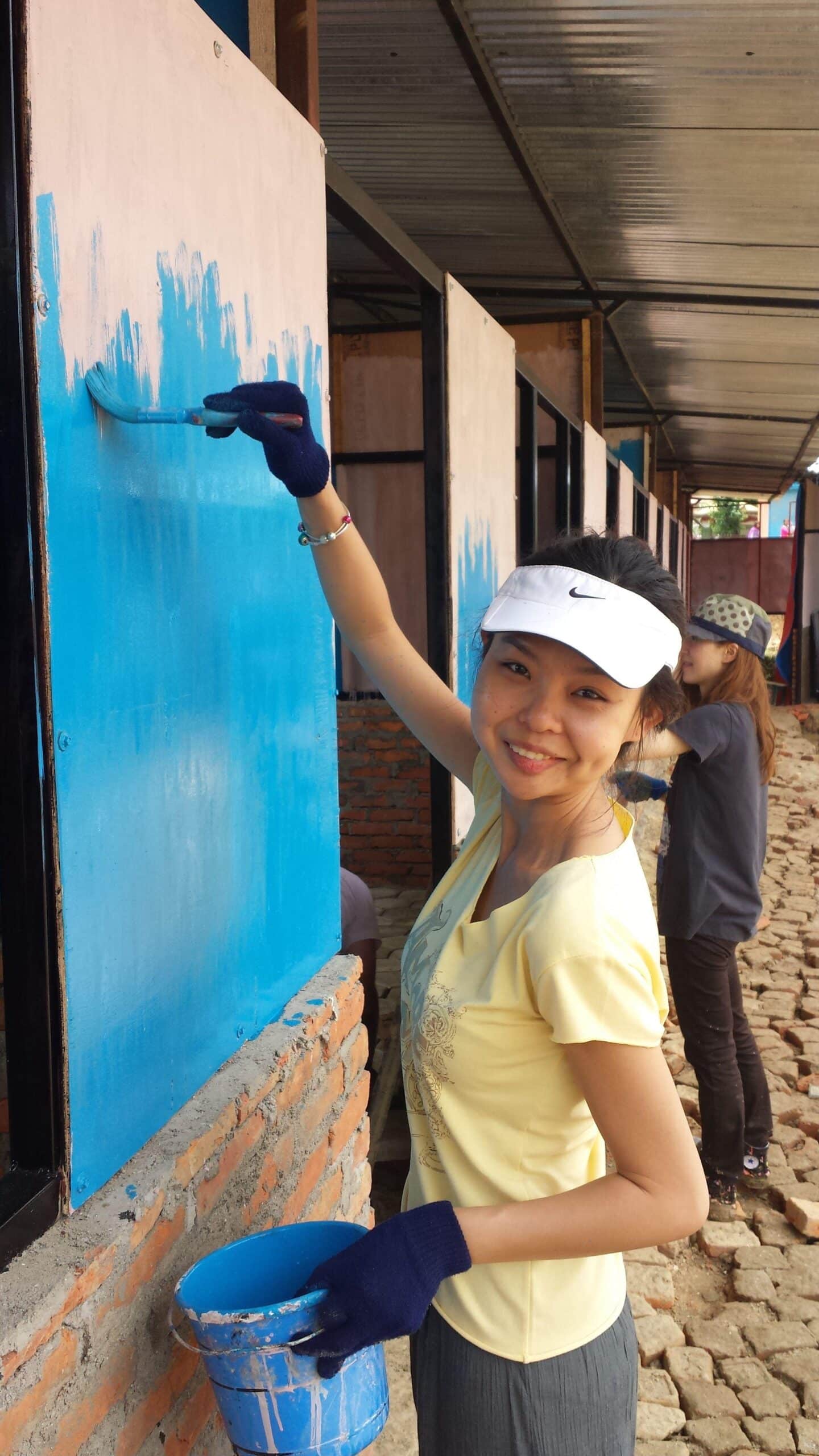 A volunteer is renovating the local classroom during her Building Project in Nepal