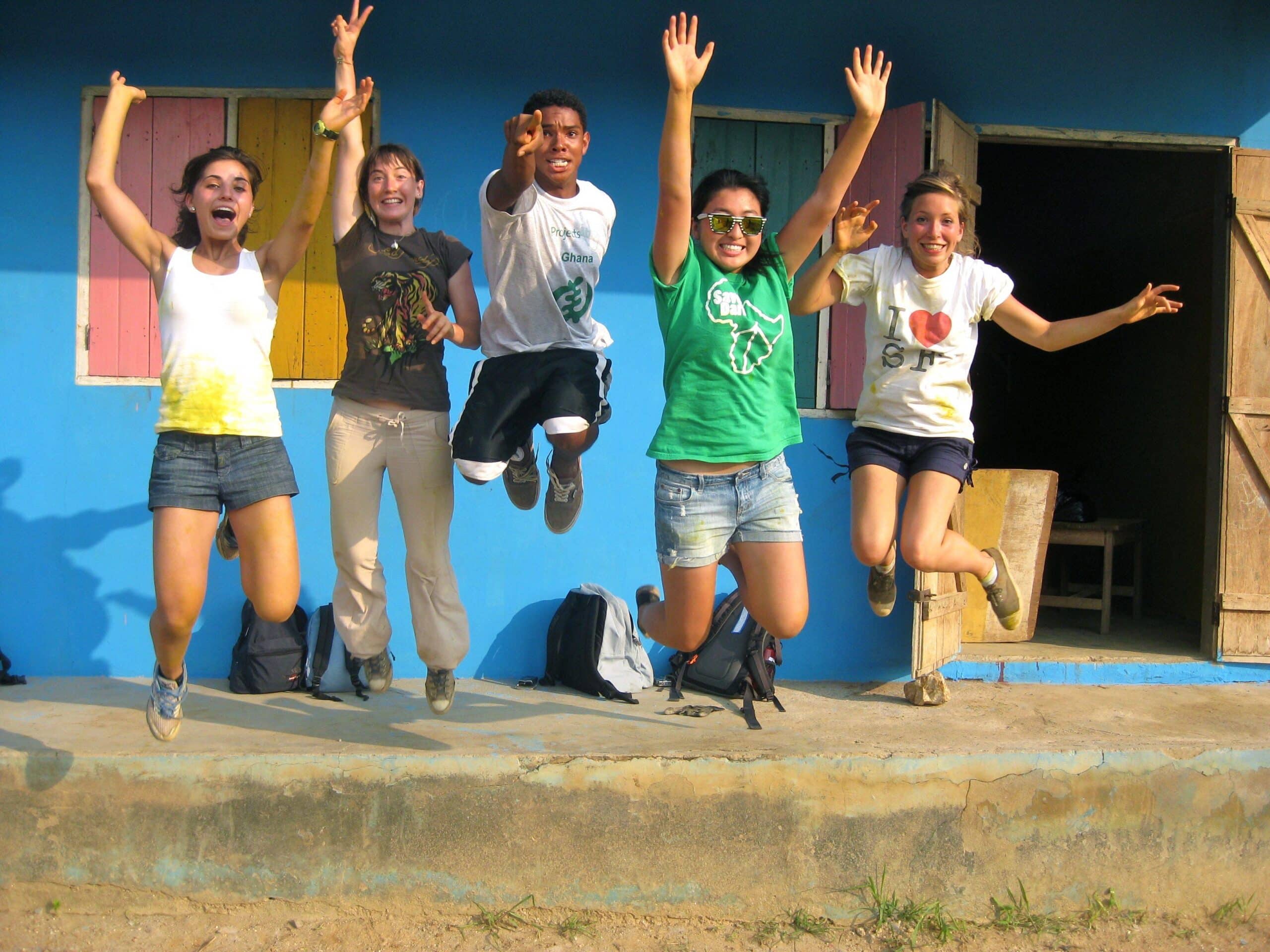 Group photo of volunteers after painting a local school in Ghana during their community volunteer work for teenagers.