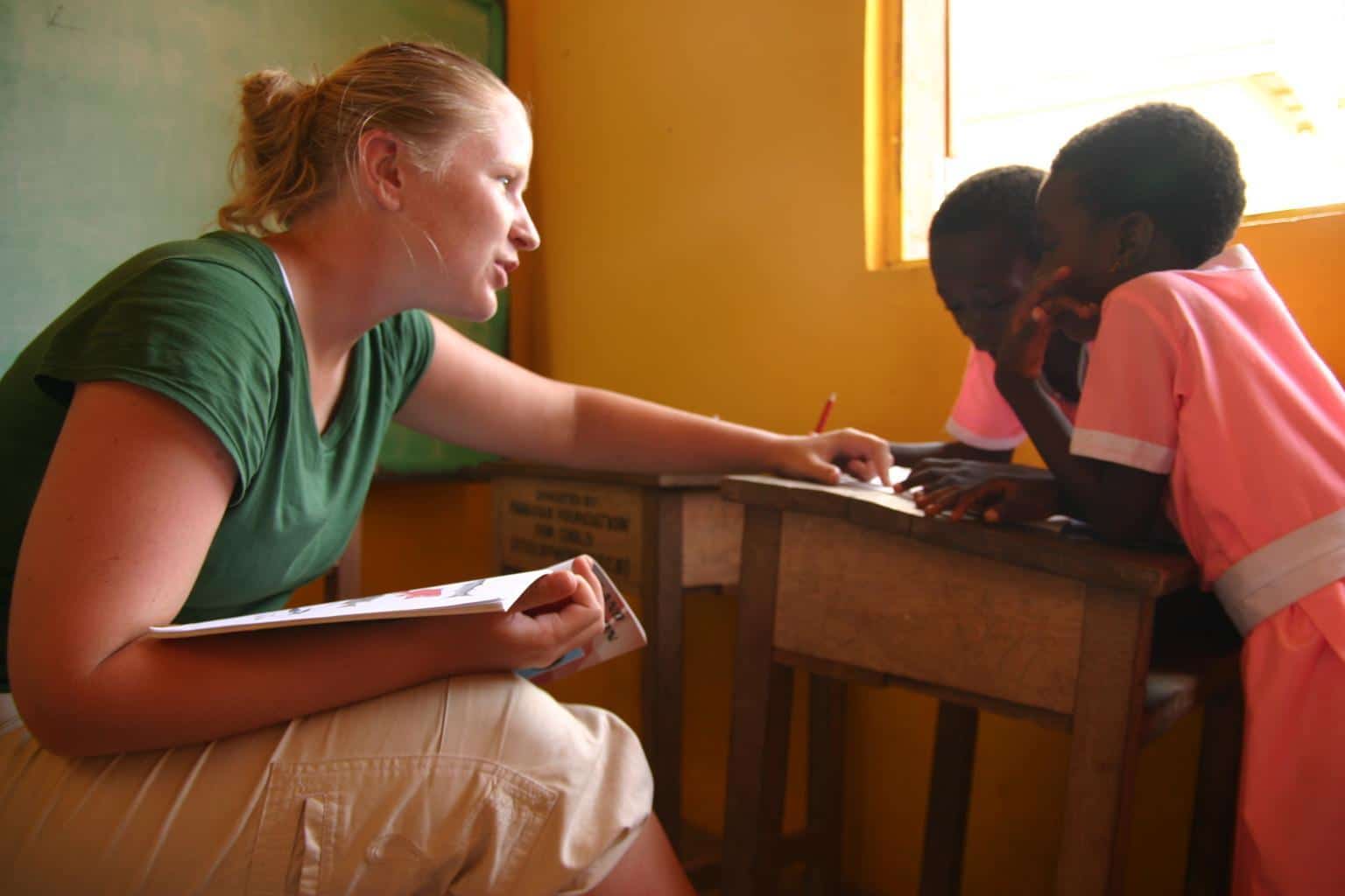 A Projects Abroad volunteer doing a speech therapy internship in Ghana works with a couple of girls.